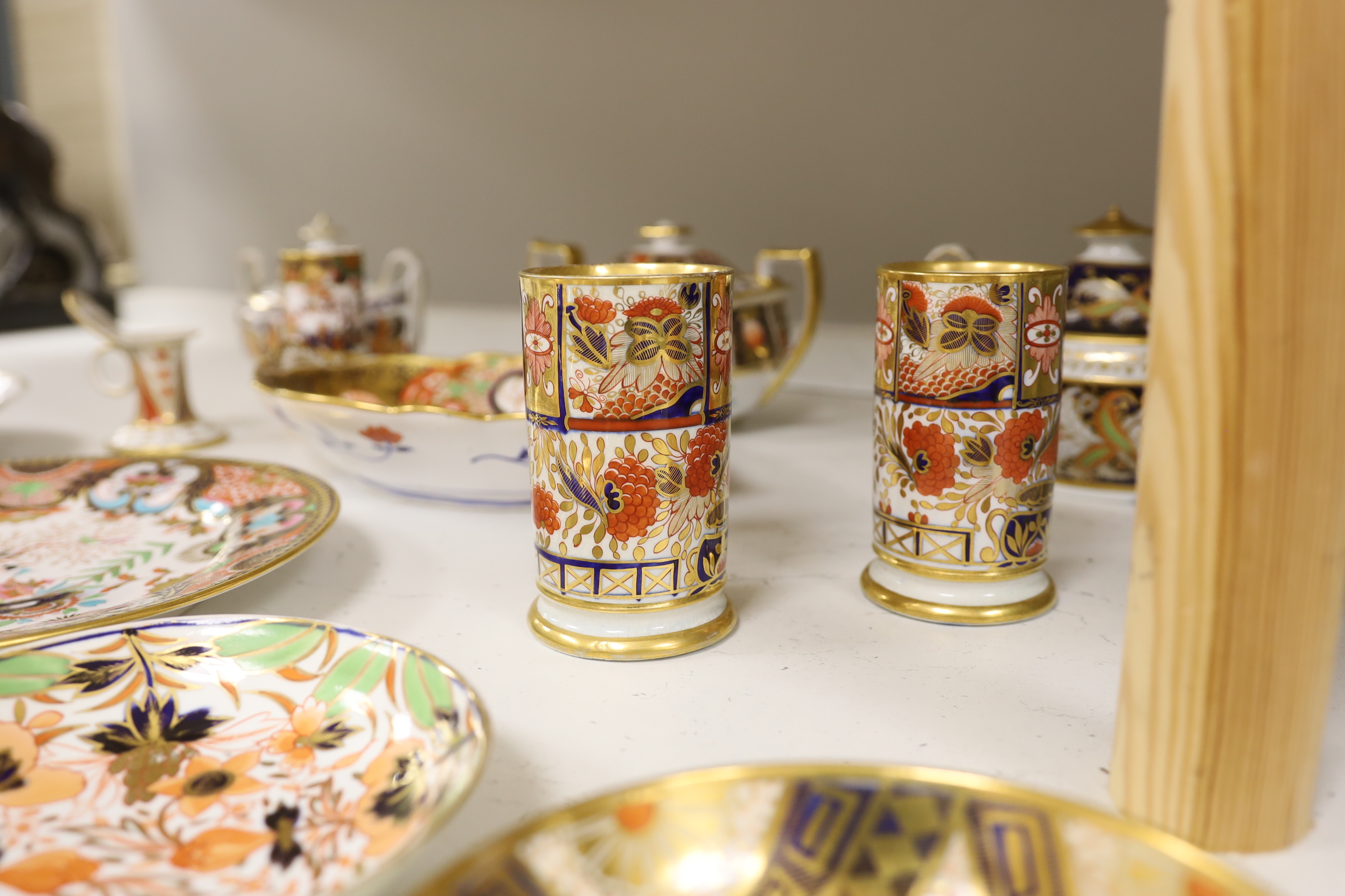 Sixteen mixed items of 1800-1820 English porcelain tableware, to include: three sucriers and covers, an oval ornately decorated dish, four saucer dishes, a candle holder, three spill vases and four saucers